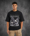 Person wearing a black t-shirt with an eagle design and text on a gray background